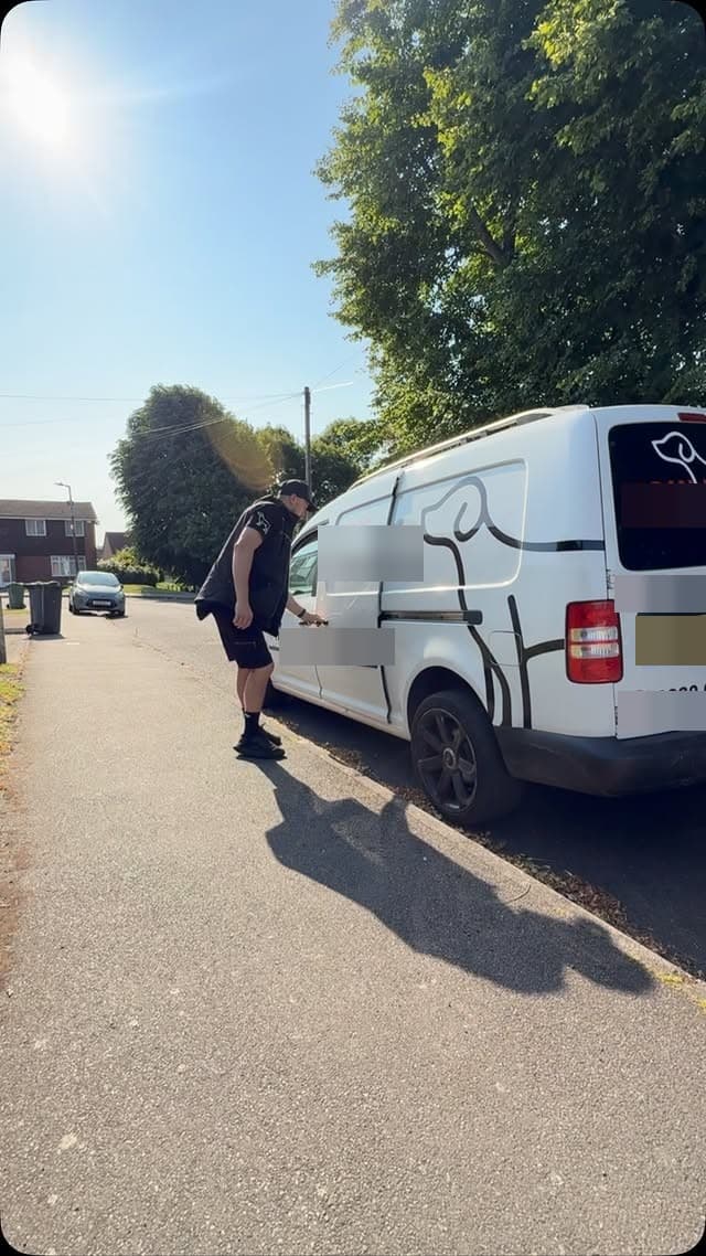 The branded van mid-pickup on a residential street